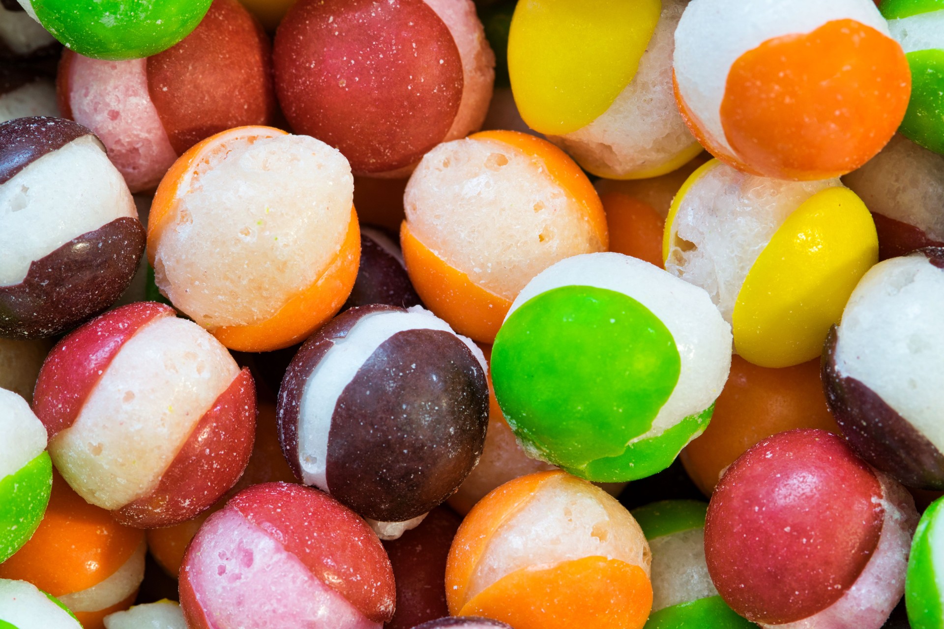 Freeze dried M&M's hard candy with splits through their centers.